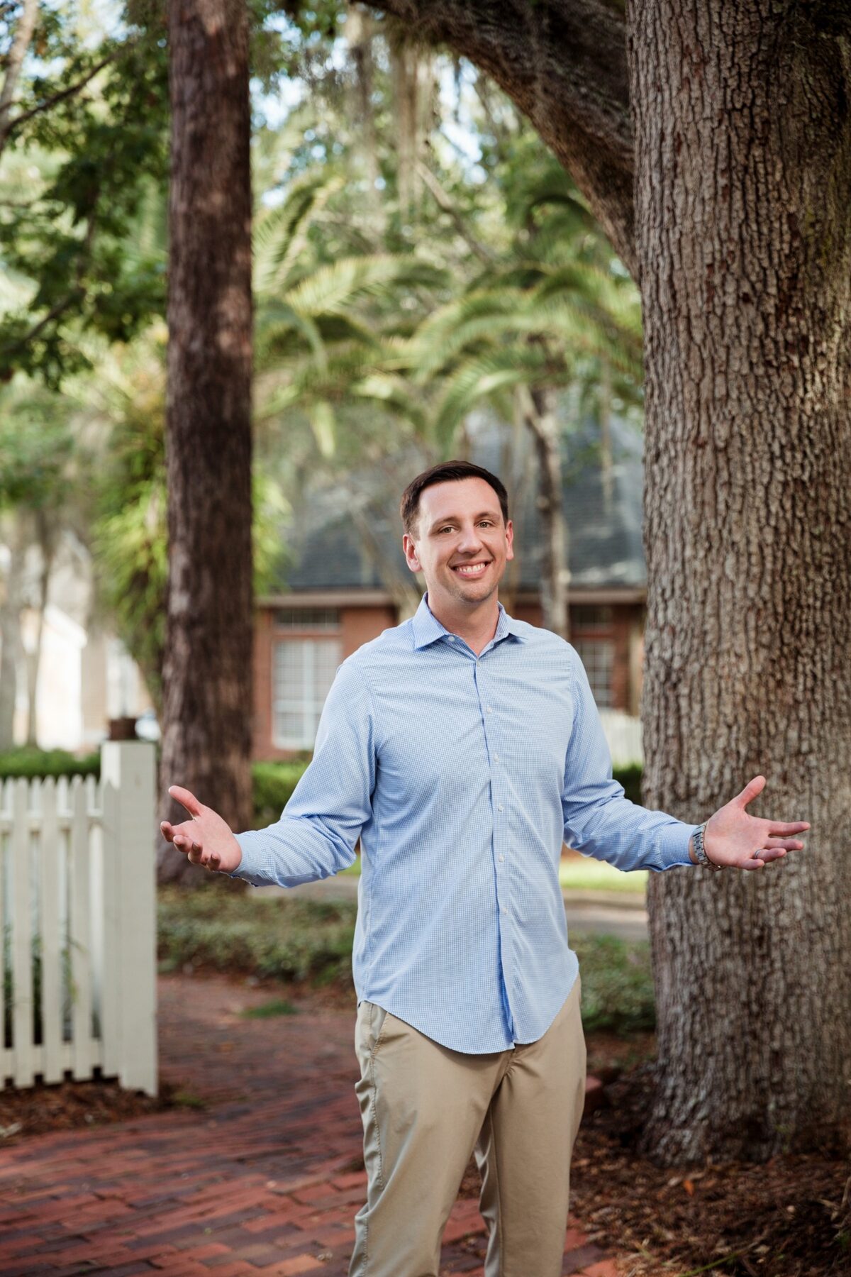 Donavan Arnold standing beneath oak trees in Gainesville